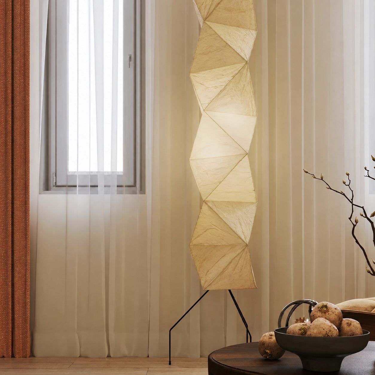 Akari UF4-L8 floor lamp beside sofa living room soft glow washi paper tall sculptural American home lifestyle interior styled