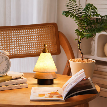 Alberello cordless table lamp on a wooden desk in a cozy home office