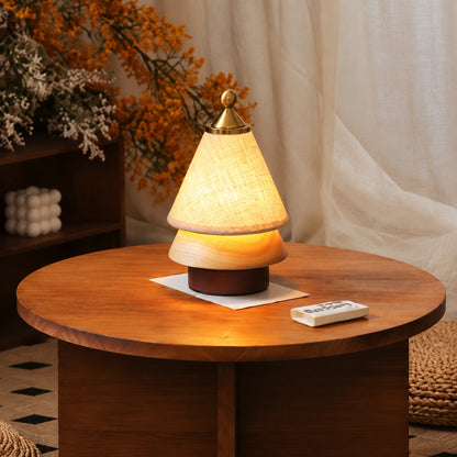 Alberello Christmas tree lamp on a cafe table beside a latte