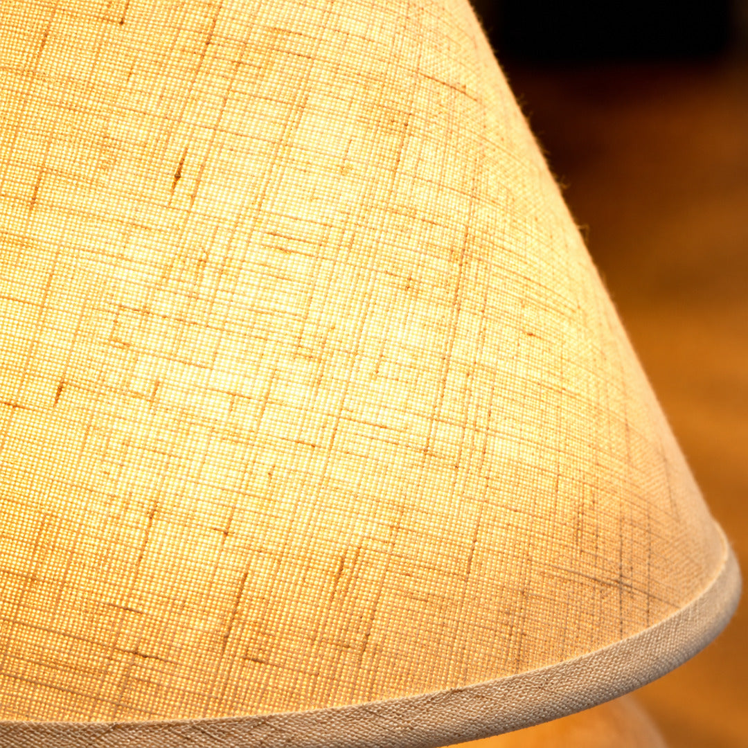 Close-up of the woven fabric shade glowing on the Alberello table lamp