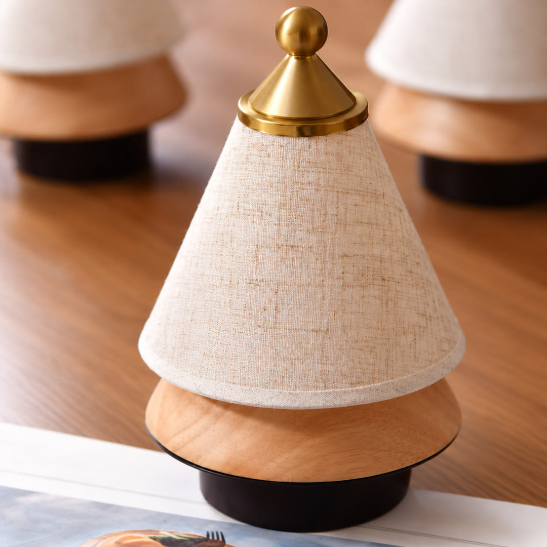 Alberello cordless lamp held in one hand to show its small 7.9 inch size
