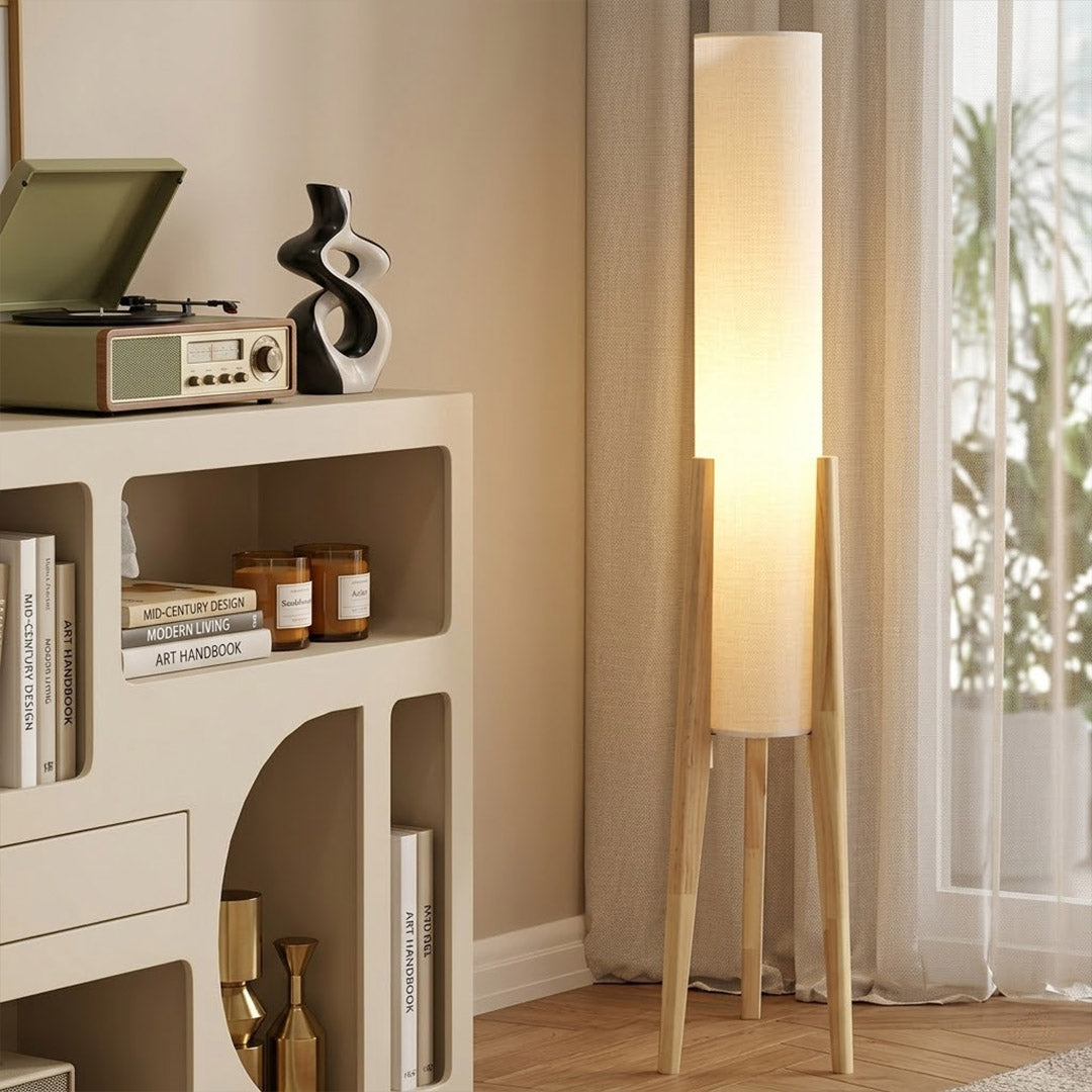 Alto walnut tripod floor lamp beside armchair living room warm light mid century modern interior