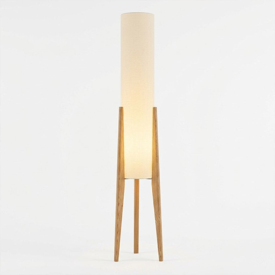 Alto walnut tripod floor lamp beside armchair living room warm light mid century modern interior