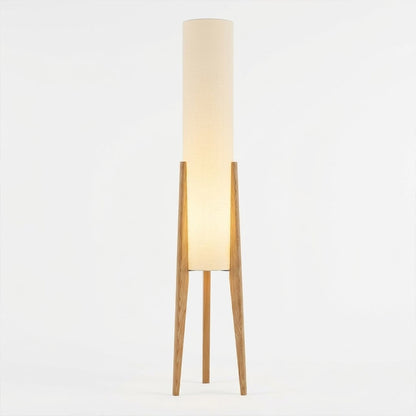 Alto walnut tripod floor lamp beside armchair living room warm light mid century modern interior