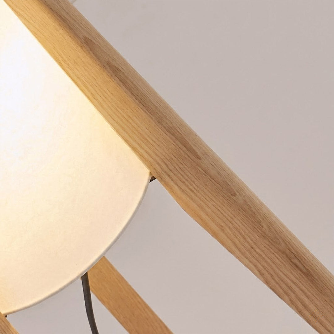 Alto walnut tripod floor lamp beside armchair living room warm light mid century modern interior
