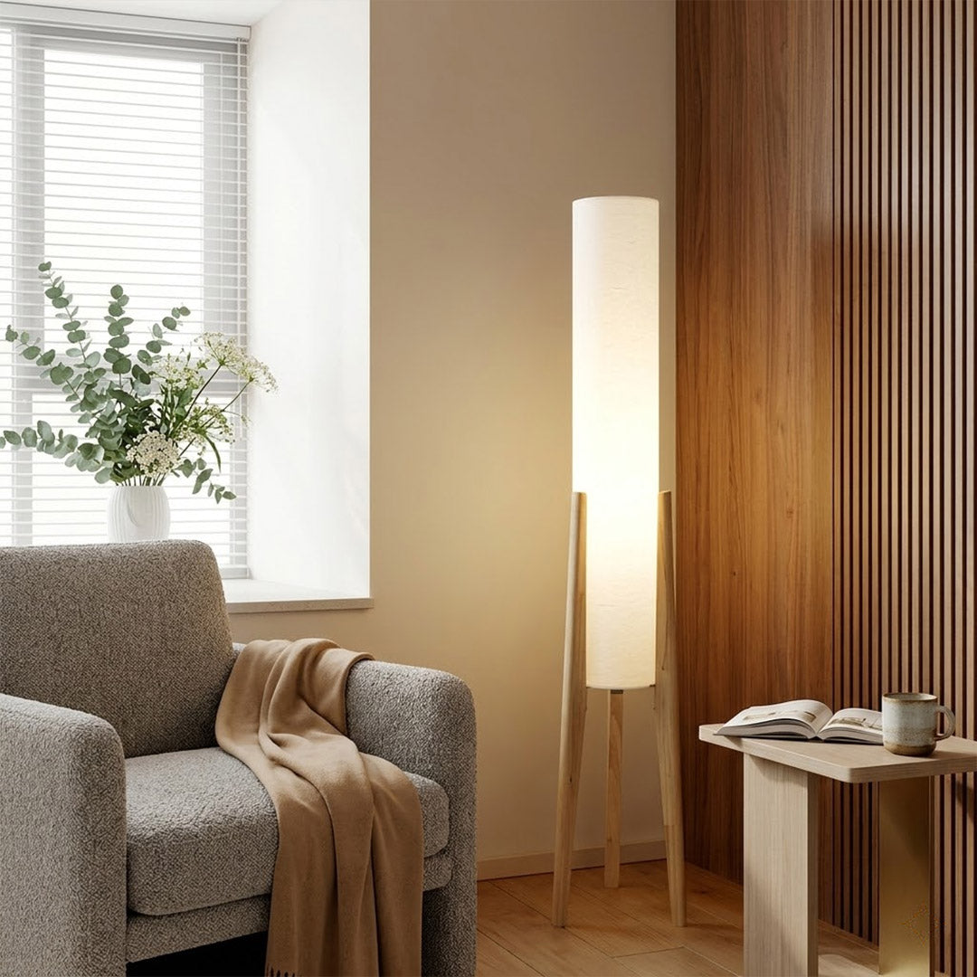 Alto walnut tripod floor lamp beside armchair living room warm light mid century modern interior