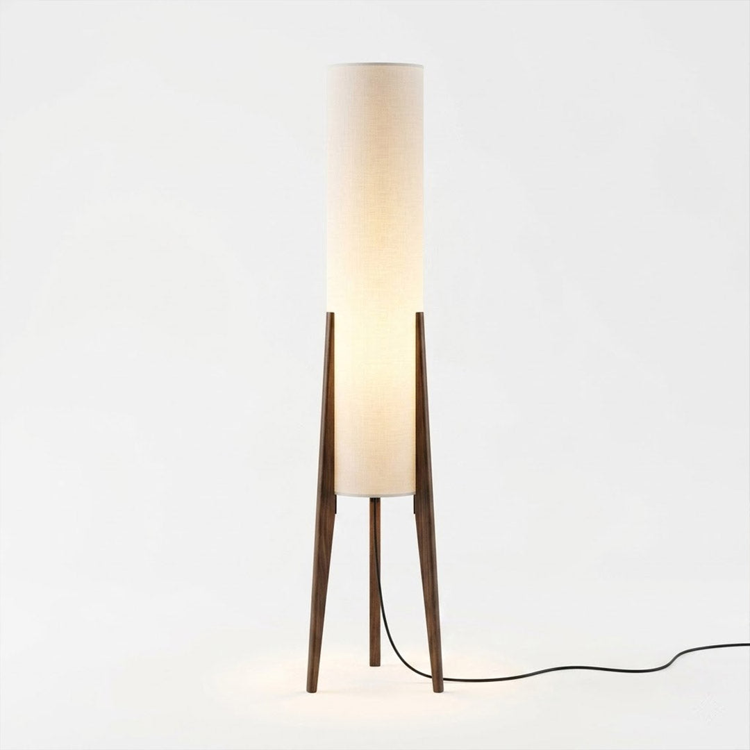 Alto walnut tripod floor lamp beside armchair living room warm light mid century modern interior