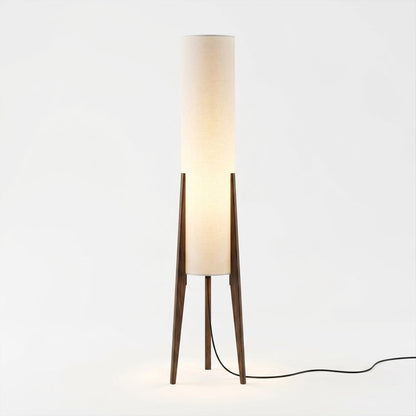 Alto walnut tripod floor lamp beside armchair living room warm light mid century modern interior