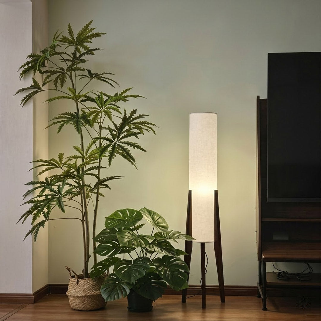 Alto walnut tripod floor lamp beside armchair living room warm light mid century modern interior
