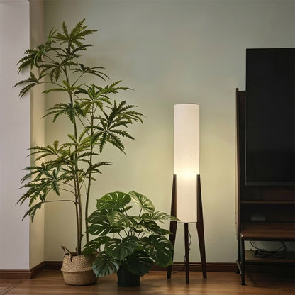 Alto walnut tripod floor lamp beside armchair living room warm light mid century modern interior