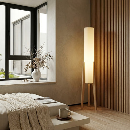 Alto walnut tripod floor lamp beside armchair living room warm light mid century modern interior