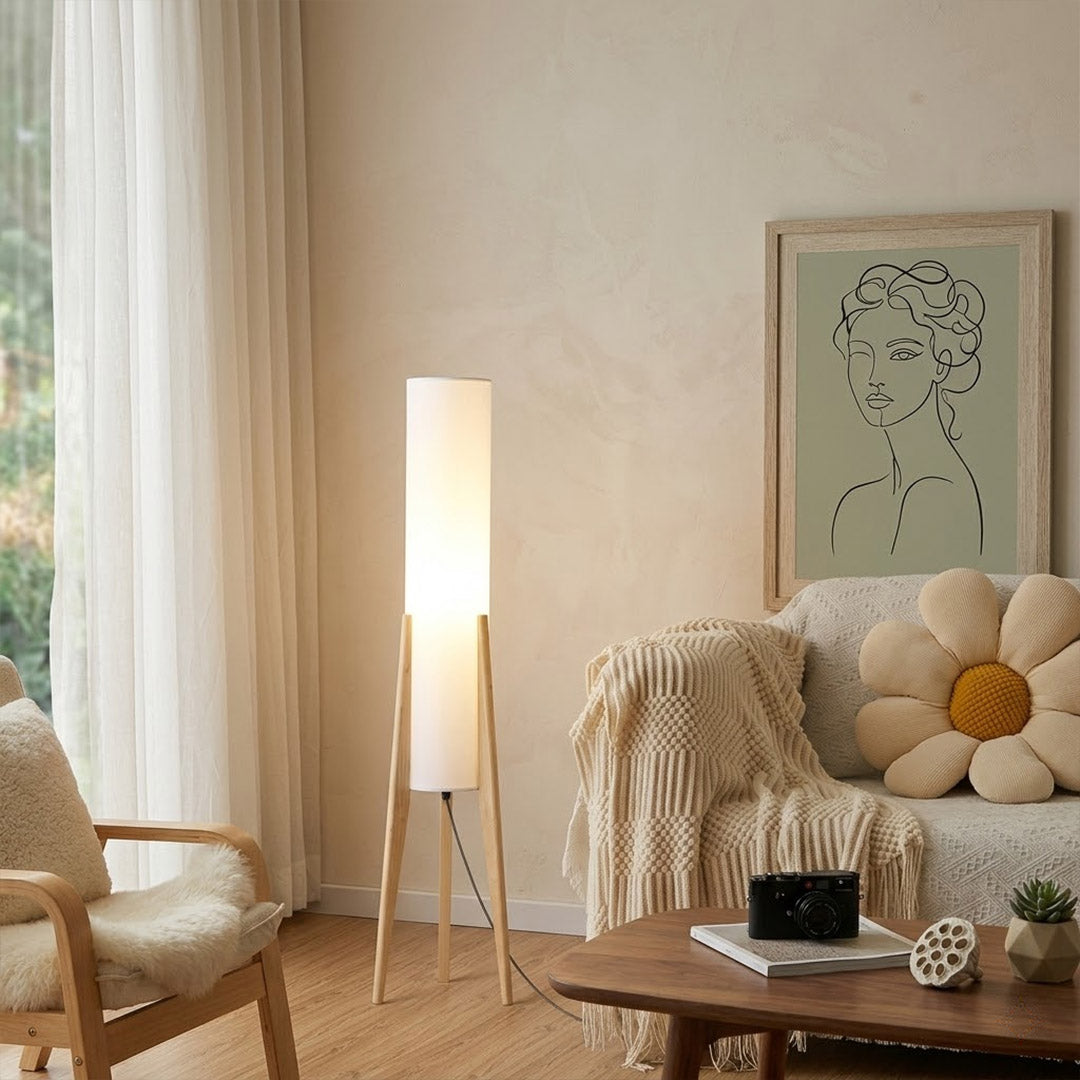 Alto walnut tripod floor lamp beside armchair living room warm light mid century modern interior