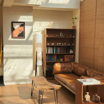 Alto walnut tripod floor lamp beside armchair living room warm light mid century modern interior
