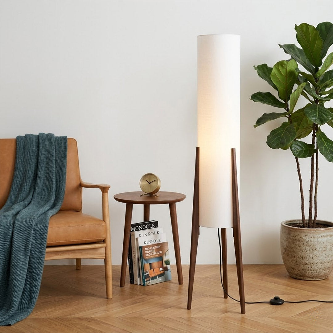 Alto walnut tripod floor lamp beside armchair living room warm light mid century modern interior