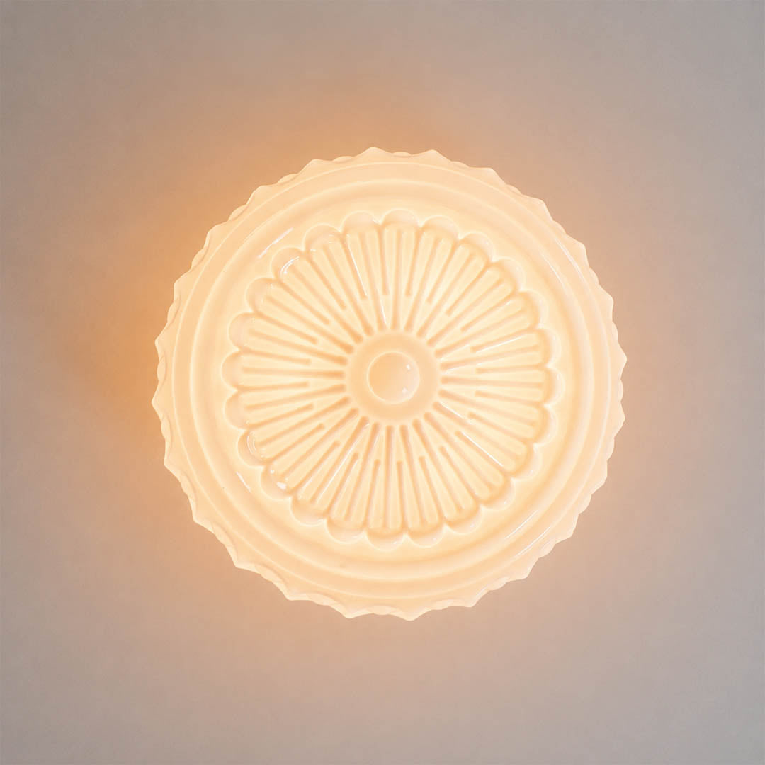 Amalfi round ceiling light illuminated patterned milk glass glowing soft textured warm light detail close up cozy