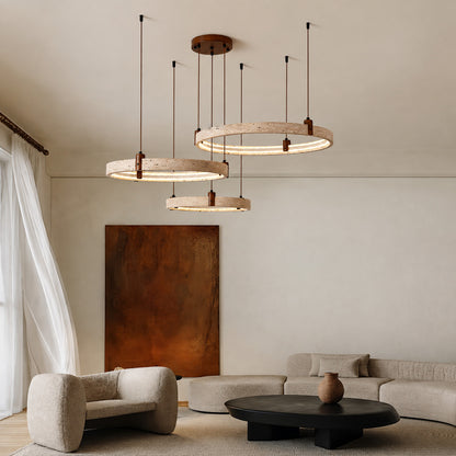 Anelli travertine chandelier living room double height open space warm glow travertine stone rings sculptural American home lifestyle interior styled