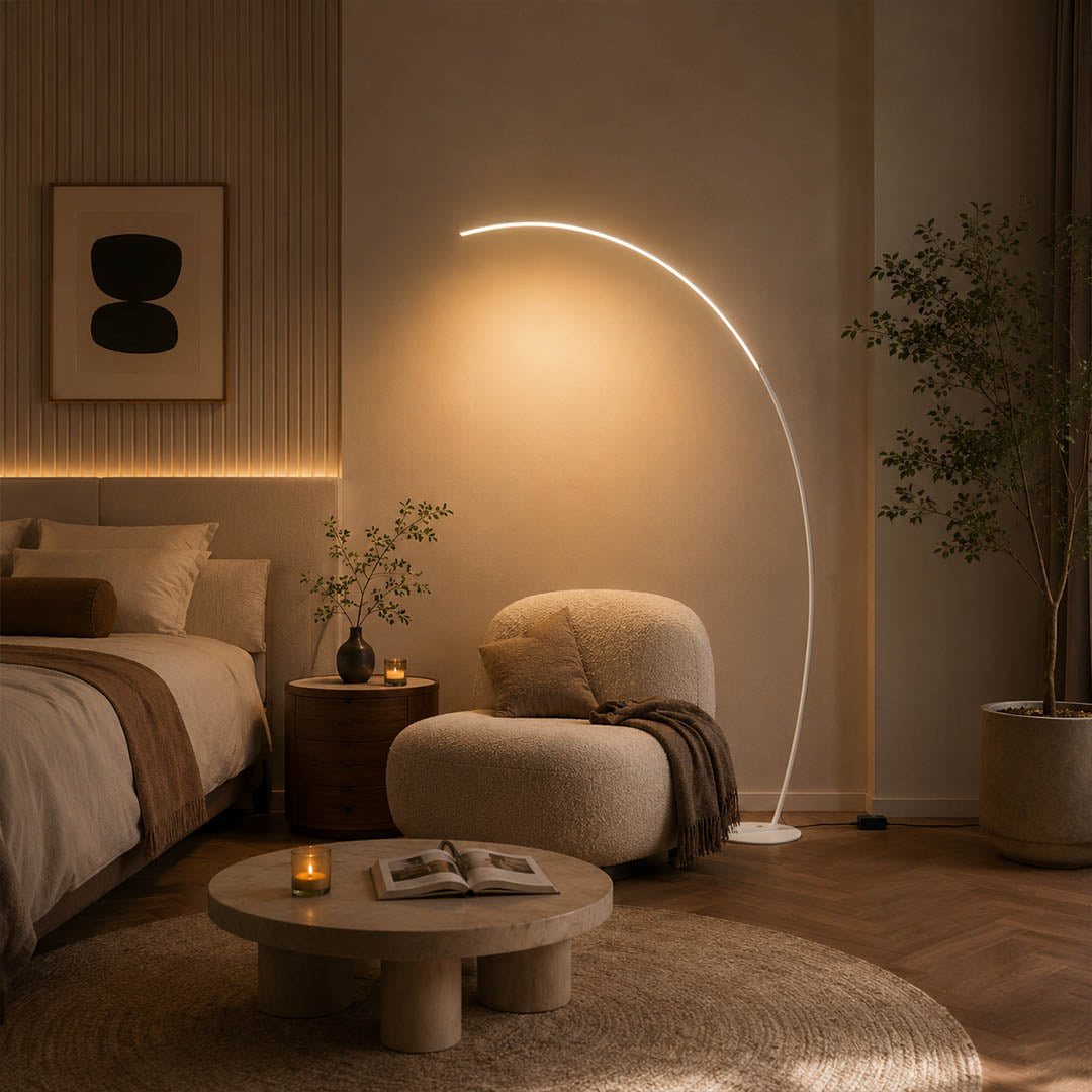 Arco floor lamp white modern primary bedroom overhead reach above bed statement arc curved mid century Italian minimalist warm ambient sculptural elegant lifestyle interior