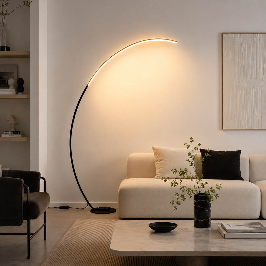 Arco floor lamp black modern living room sectional sofa overhead reach arc curved statement mid century Italian minimalist warm ambient sculptural elegant lifestyle interior