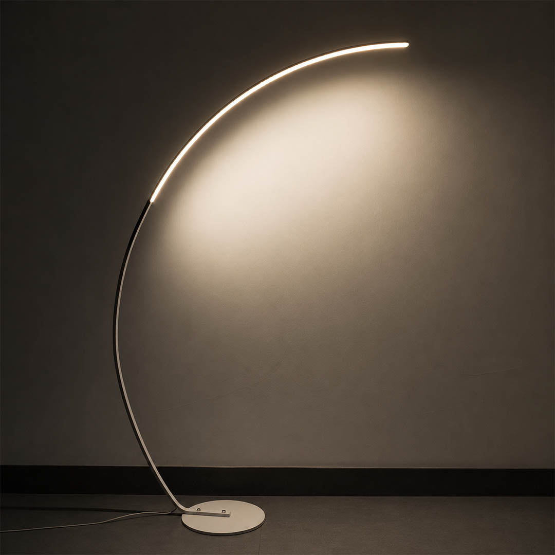 Arco floor lamp black modern home office corner overhead reach arc curved statement mid century Italian minimalist warm ambient sculptural functional lifestyle interior