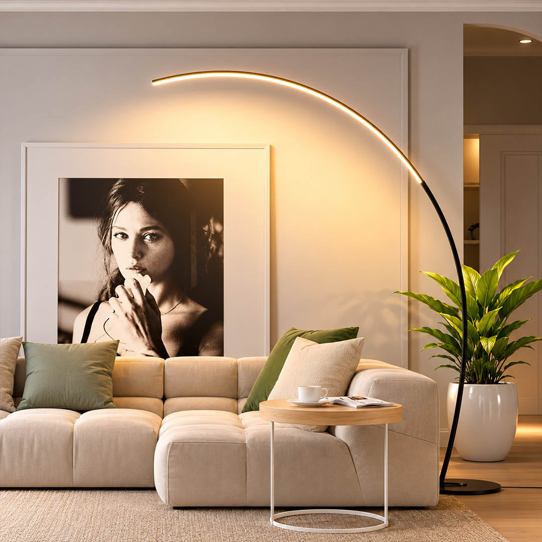 Arco floor lamp black modern living room sectional sofa overhead reach arc curved statement mid century Italian minimalist warm ambient sculptural elegant lifestyle interior