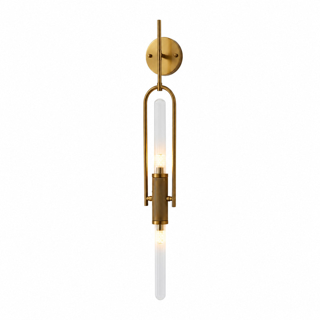 Arco glass wall sconce with a long arced arm and a clear glass cylinder shade glowing warm on a wall