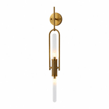 Arco glass wall sconce with a long arced arm and a clear glass cylinder shade glowing warm on a wall
