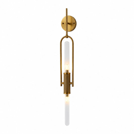 Arco glass wall sconce with a long arced arm and a clear glass cylinder shade glowing warm on a wall