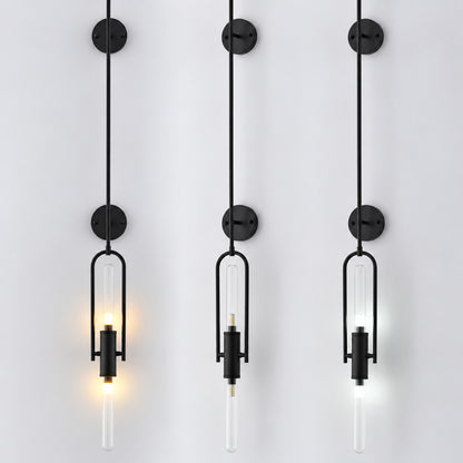 Warm light glowing through the clear glass cylinder of the Arco wall sconce