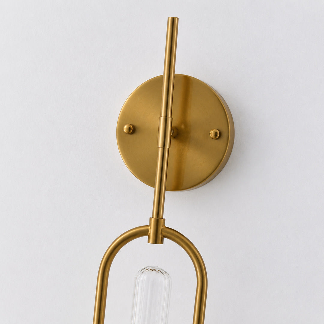 Gold and black arm finishes of the Arco glass wall sconce shown side by side