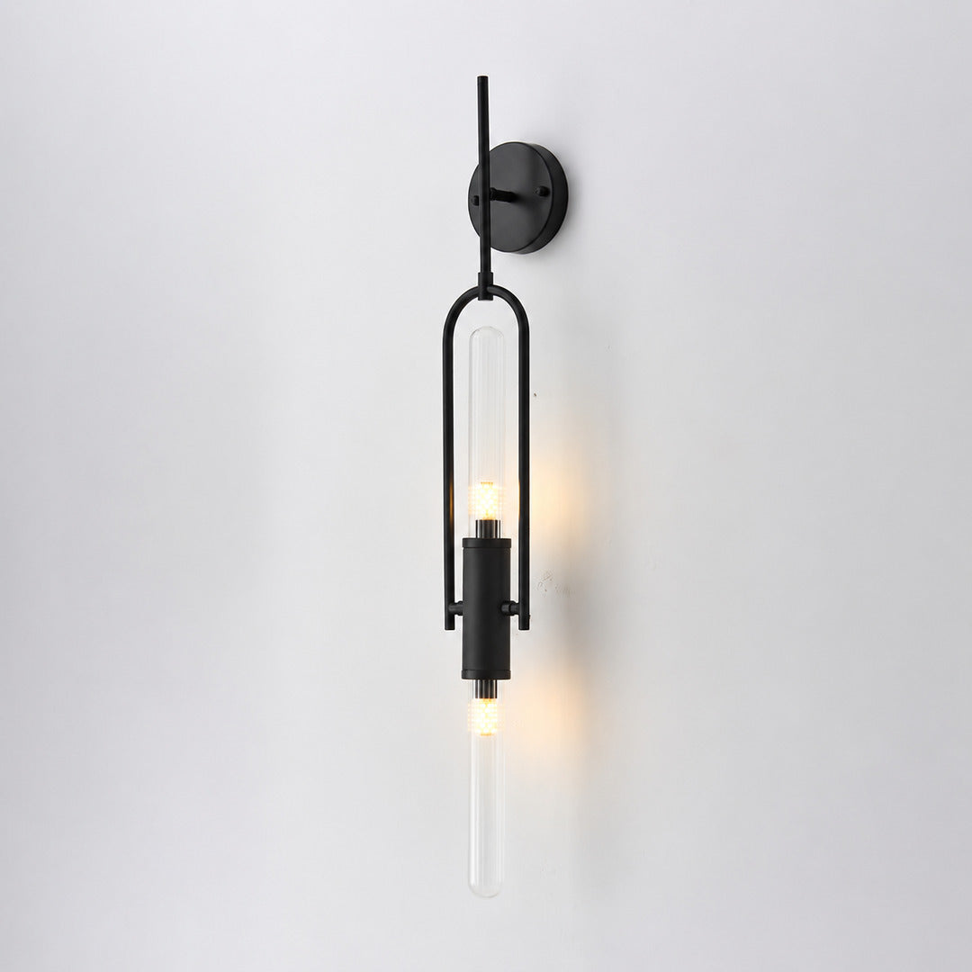 Short 33.5-inch black Arco glass wall sconce as a slim accent beside a bed