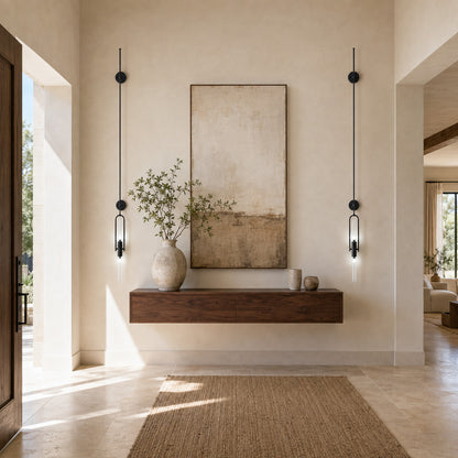 Arco glass wall sconce welcoming guests with a warm arced silhouette above an entry console