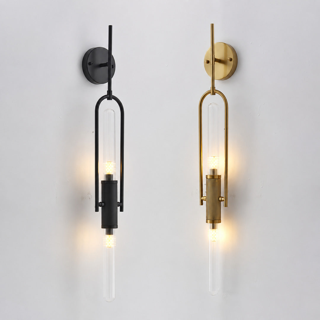 Gold and black arm finishes of the Arco glass wall sconce shown side by side