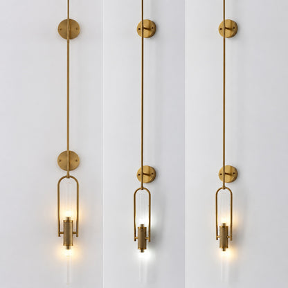Warm light glowing through the clear glass cylinder of the Arco wall sconce