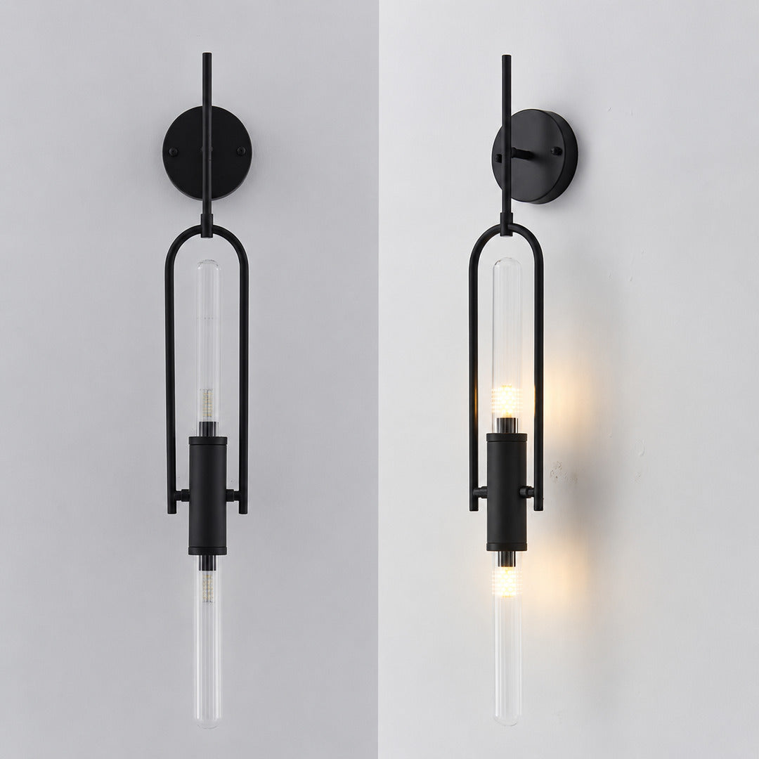 Warm light glowing through the clear glass cylinder of the Arco wall sconce