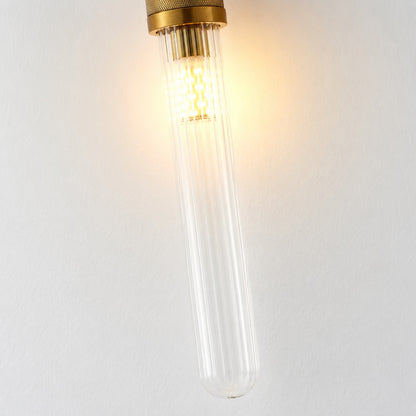 Detail of the clear cylindrical glass shade on the Arco wall sconce diffusing a warm glow