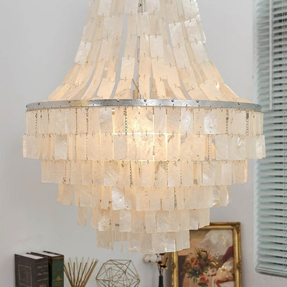Aria small boho Capiz shell tiered chandelier coastal Bohemian bedroom master primary natural linen rattan warm glow lifestyle interior