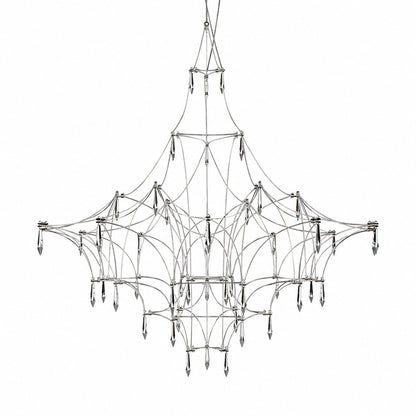 Astra crystal chandelier with a geometric wire frame and teardrop crystals glowing warm over a dining table