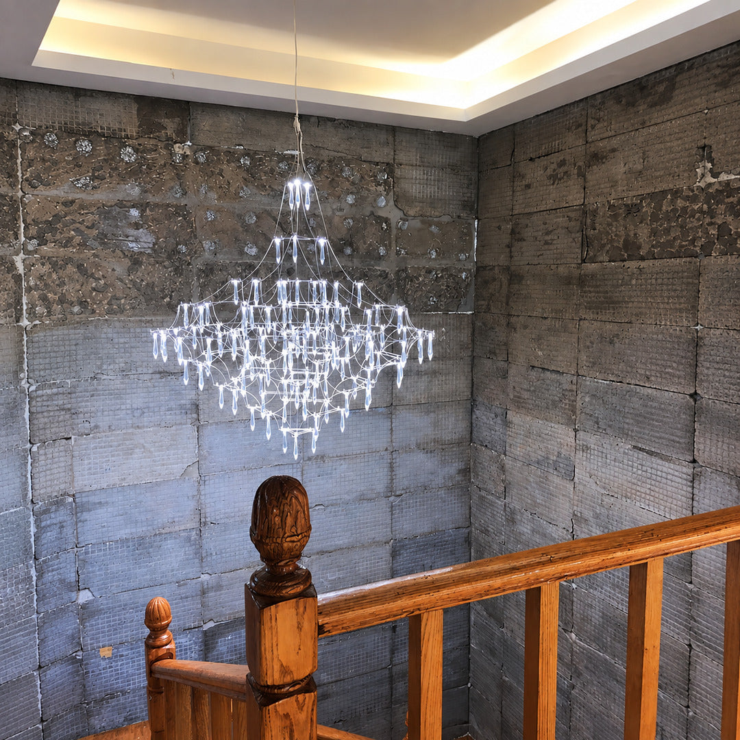 Astra crystal chandelier cascading down an open staircase stairwell with sparkling crystals