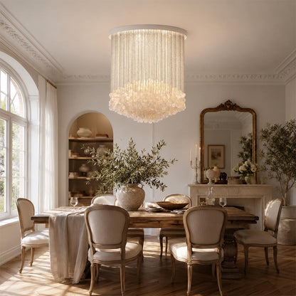 Contemporary glass multi-tier flush mount ceiling lamp over a detailed wooden dining set, creating warm ambiance.