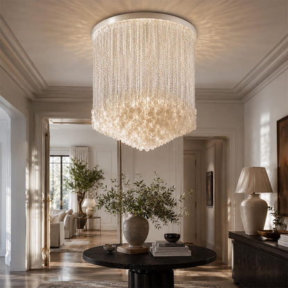 Statement-making glass cylinder flush mount ceiling light in a formal dining room, positioned over a dark table.