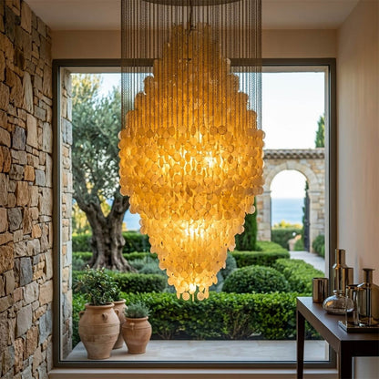 Aurelia FUN style grand cascade shell chandelier oceanfront modern mansion ocean view glass walls Coastal Mid Century designer mansion scale warm glow lifestyle interior