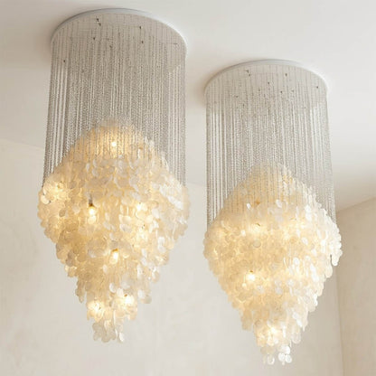Aurelia 7DM FUN style grand cascade shell chandelier vaulted living room 16 ft ceiling grand mansion Coastal Mid Century designer warm glow lifestyle interior