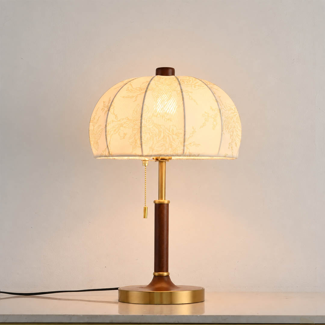 Aurelle floral fabric table lamp illuminated warm glow floral fabric shade walnut wood gold soft cozy white background