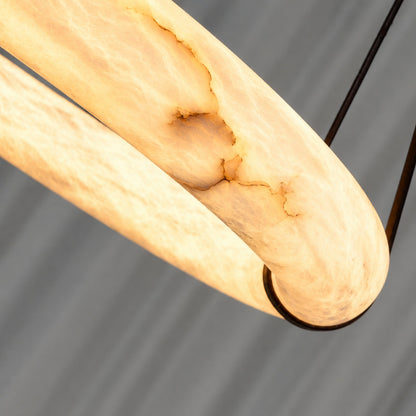 Natural veining and translucency of the alabaster ring on the Aureo pendant light, unique to each piece