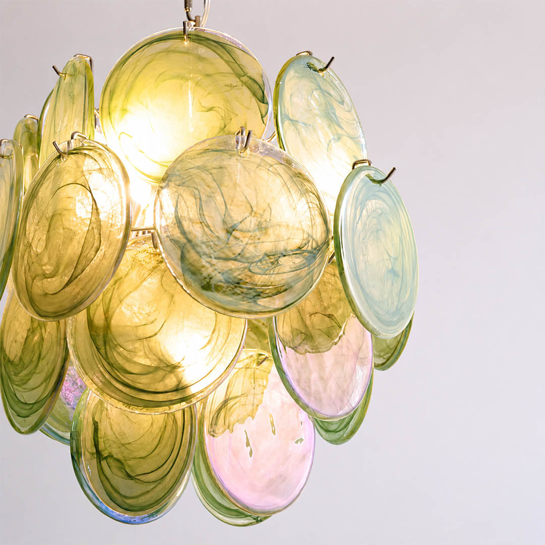 Aurora illuminated iridescent Murano glass discs warm 2700K kaleidoscopic glow evening atmosphere mesmerizing shimmer luminous detail close up modern statement
