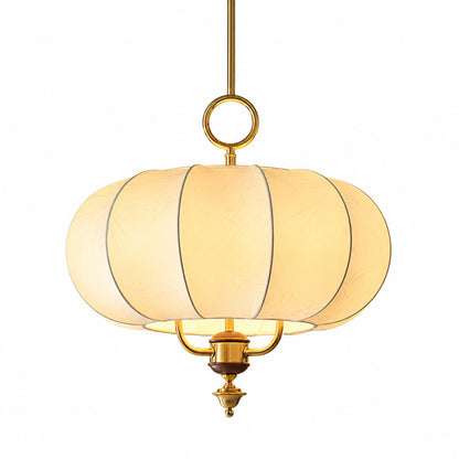 Belle lantern pendant light with a vintage floral cage design in gold and beige glowing warm over a dining table