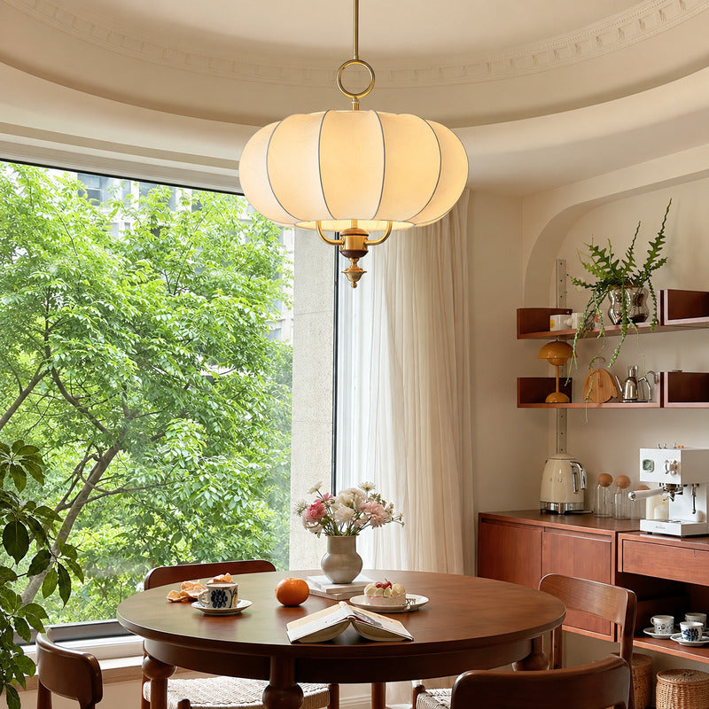 Belle floral lantern pendant casting a warm romantic glow over an elegant dining table