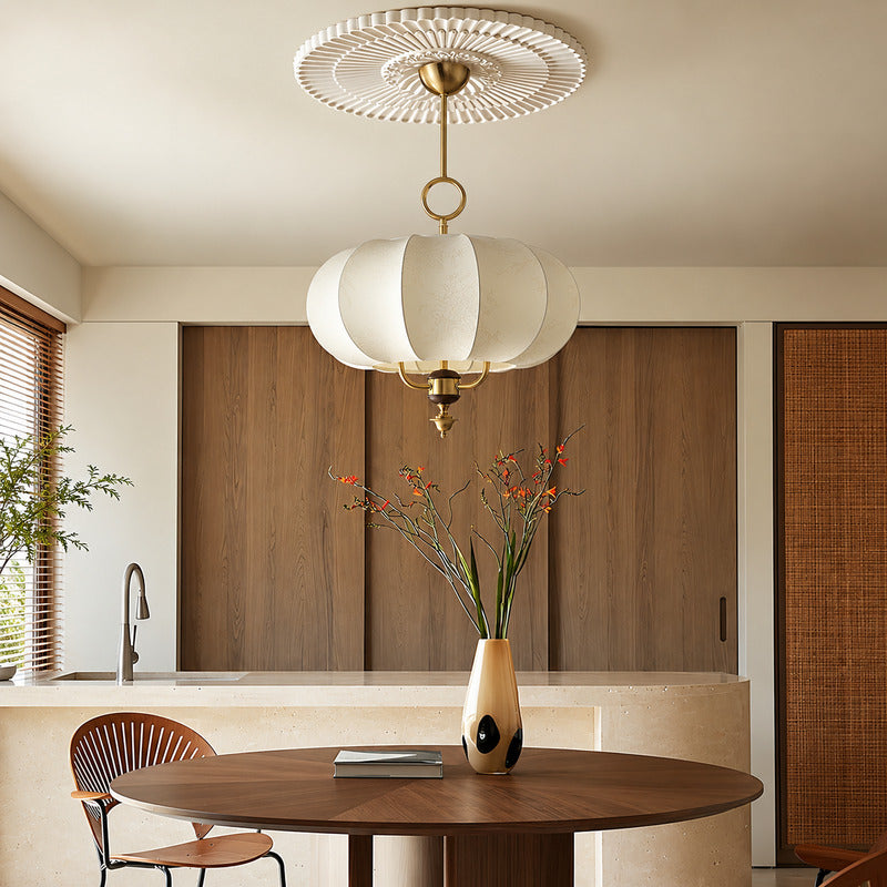 Belle floral lantern pendant casting a warm romantic glow over an elegant dining table