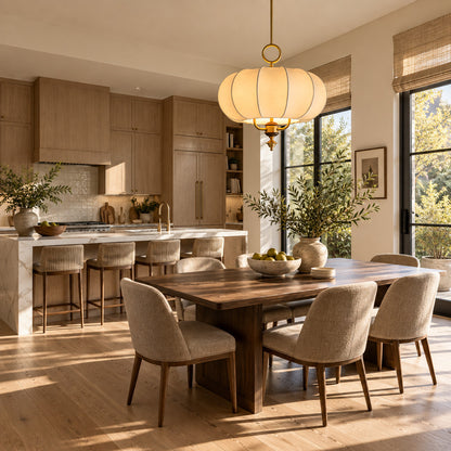 Belle lantern pendant casting a soft warm glow over an elegant dining table