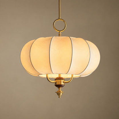Warm diffused glow through the beige fabric panels of the Belle lantern pendant
